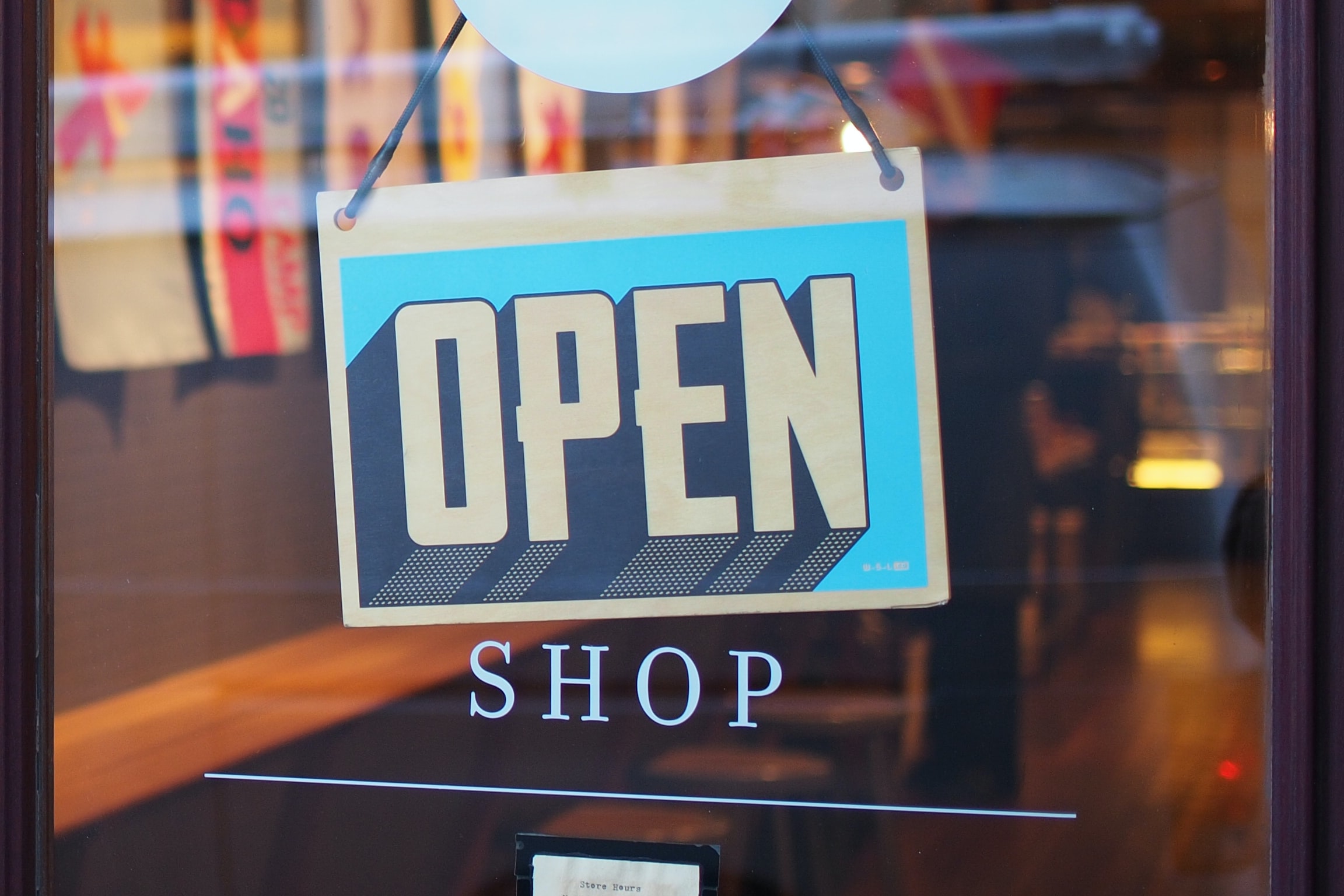 Open sign showing in a store's glass door