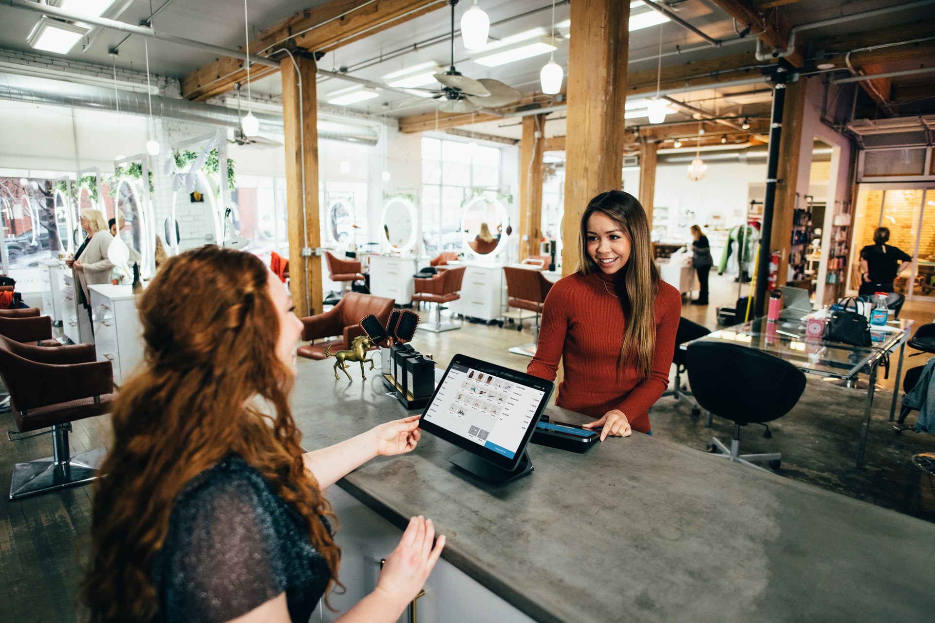 Two happy women making a transaction