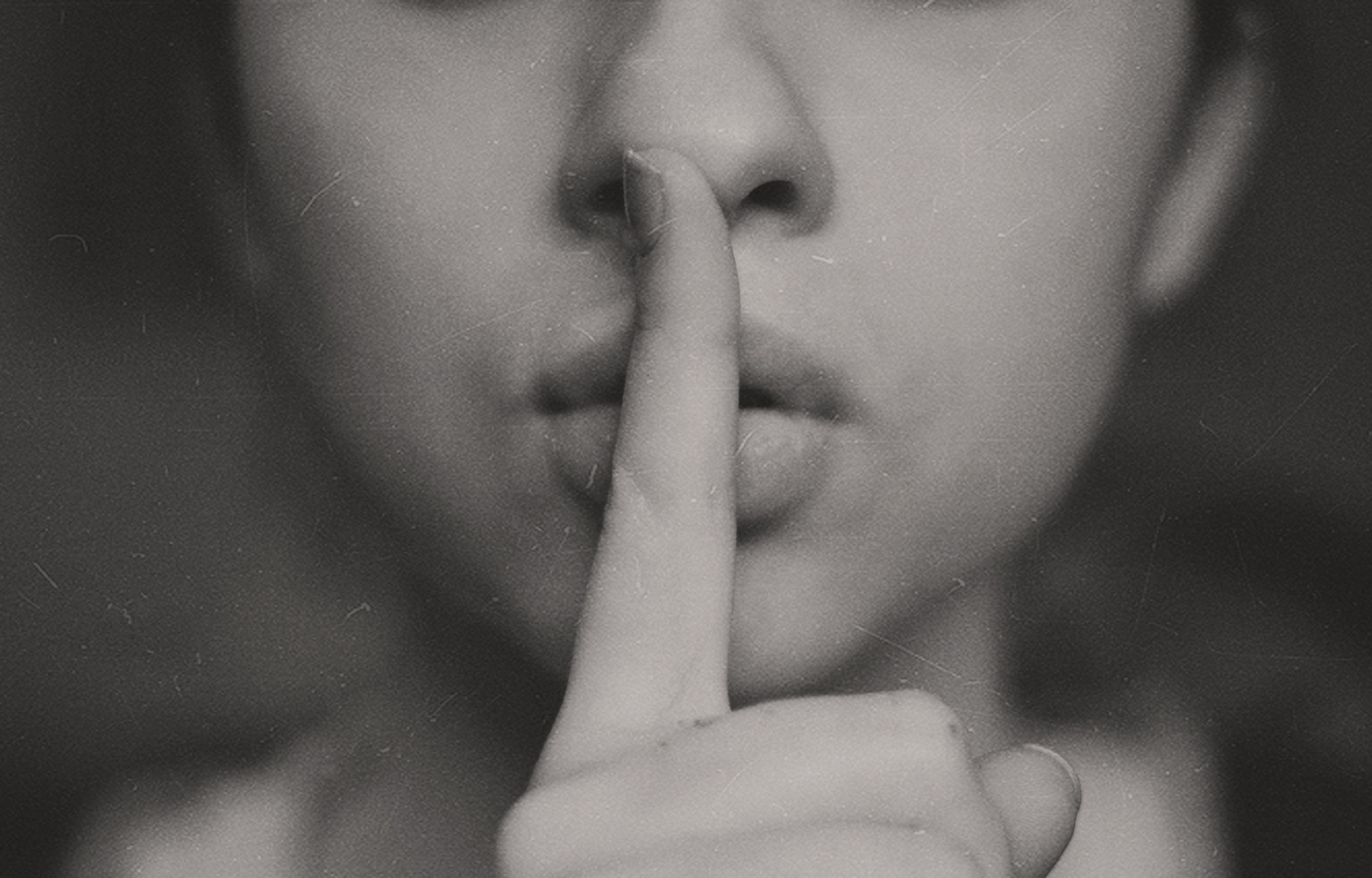 Woman making 'silent' hand sign